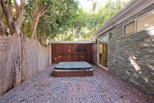 wooden deck featuring a covered hot tub