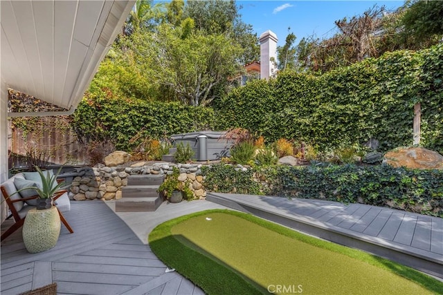 view of yard featuring a hot tub and a deck