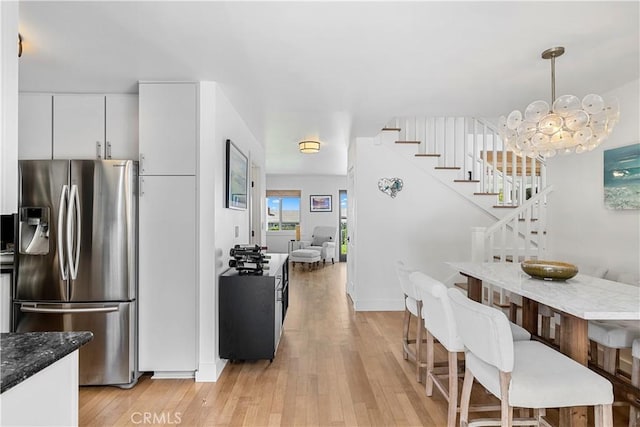 dining area featuring a notable chandelier and light hardwood / wood-style flooring