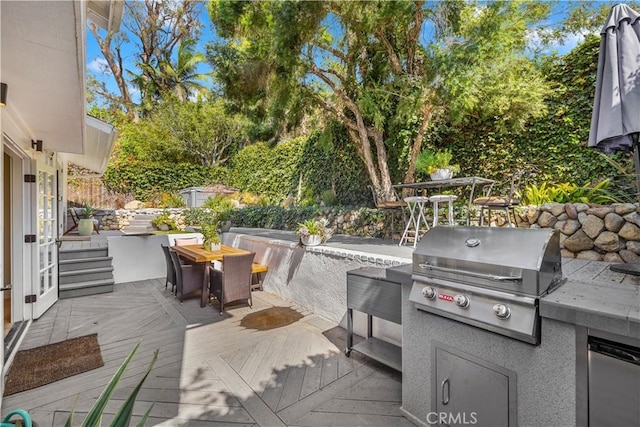 view of patio / terrace featuring a wooden deck, area for grilling, and grilling area