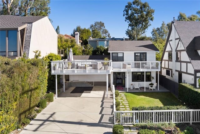 back of house with a wooden deck and a balcony