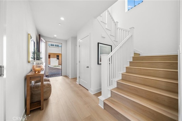 staircase featuring wood-type flooring and plenty of natural light