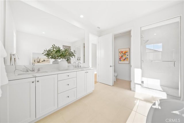 bathroom featuring toilet, tile patterned flooring, a shower with shower door, and vanity