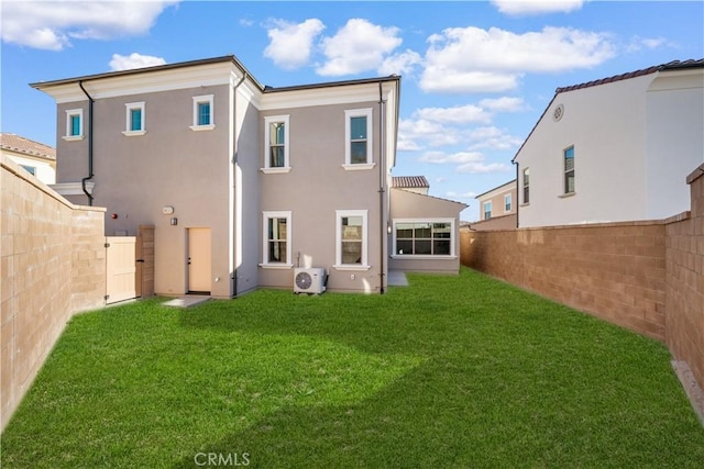 back of house featuring ac unit and a yard