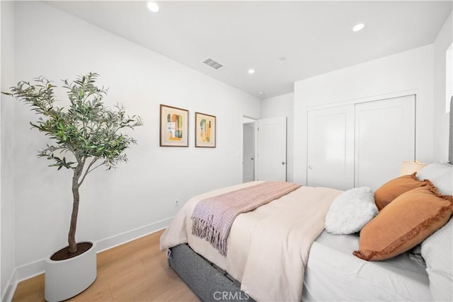 bedroom featuring light wood-type flooring and a closet