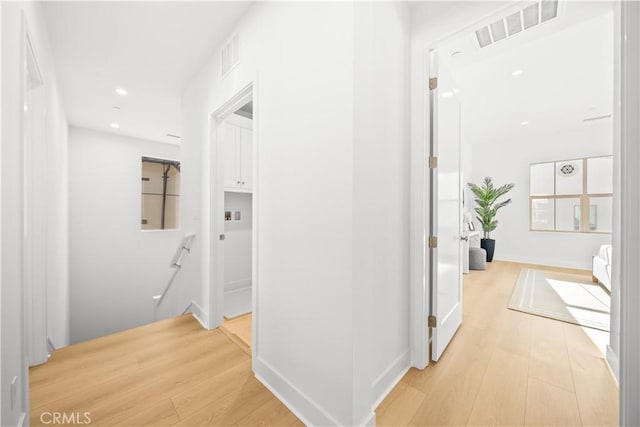 corridor with light hardwood / wood-style floors