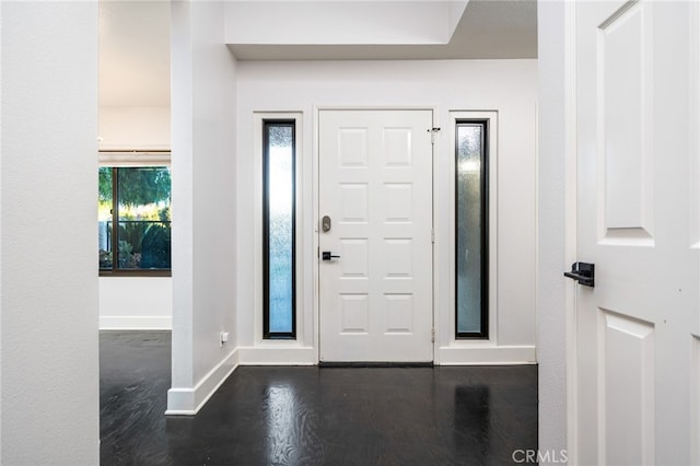 foyer with dark hardwood / wood-style floors