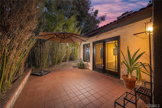 view of patio terrace at dusk