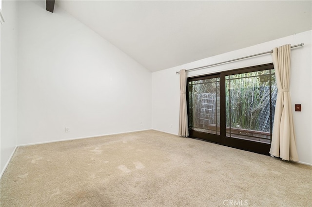 carpeted empty room featuring lofted ceiling with beams