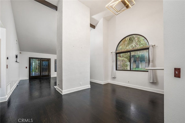 unfurnished living room with dark hardwood / wood-style flooring, high vaulted ceiling, and beamed ceiling