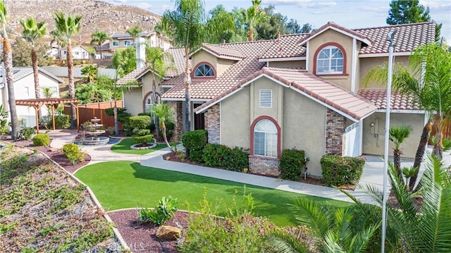 mediterranean / spanish-style home with a front lawn