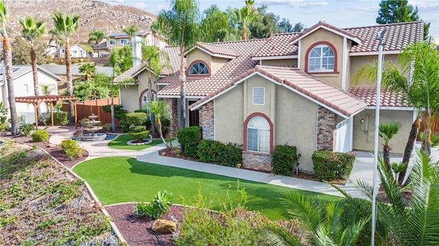 mediterranean / spanish home featuring a front lawn