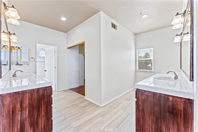 bathroom featuring hardwood / wood-style flooring and vanity