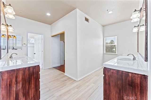 bathroom featuring wood-type flooring and vanity