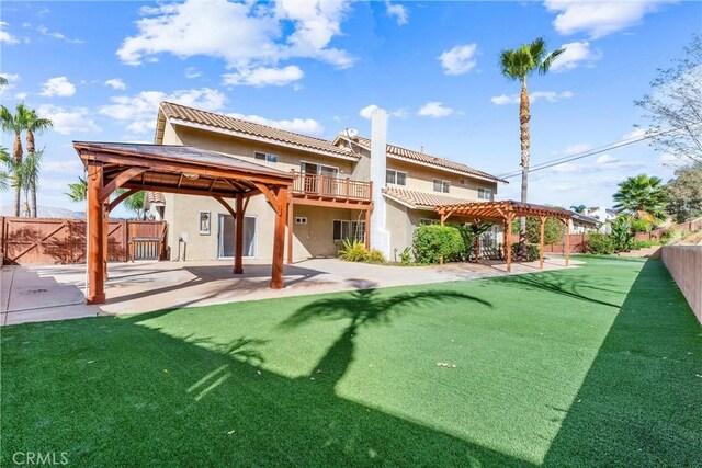 back of property featuring a patio, a yard, and a pergola