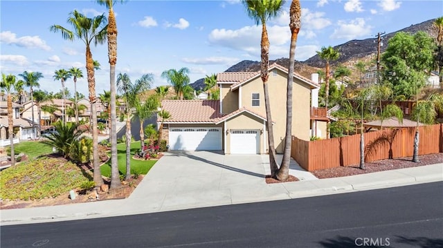 view of front of home with a mountain view and a garage