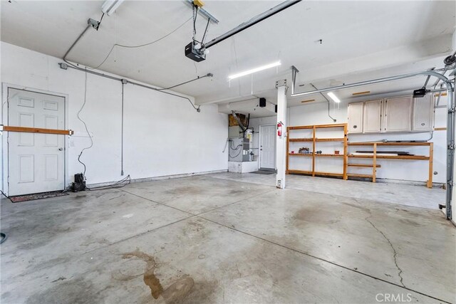 garage featuring a garage door opener and heating unit