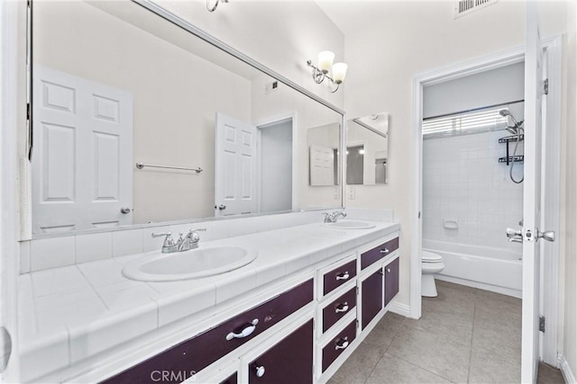 full bathroom with tile patterned floors, vanity, toilet, and tiled shower / bath