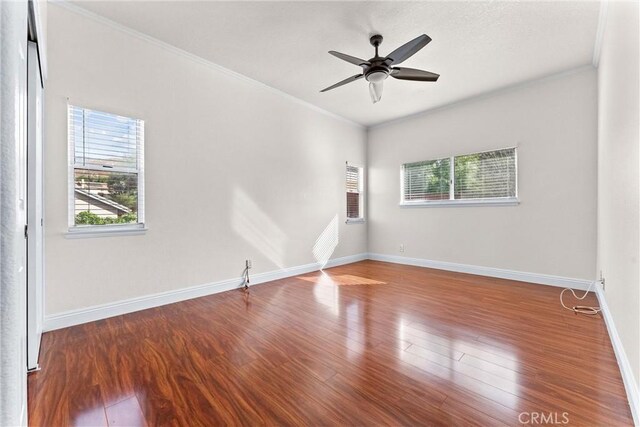 unfurnished room featuring wood-type flooring, ornamental molding, and ceiling fan