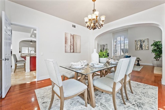 dining room featuring an inviting chandelier and wood-type flooring