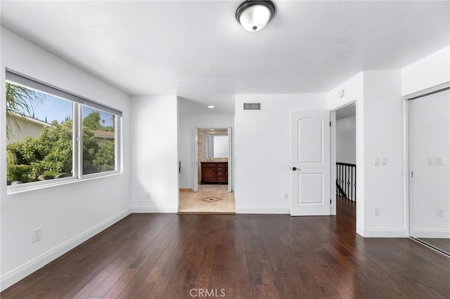 spare room featuring dark hardwood / wood-style flooring