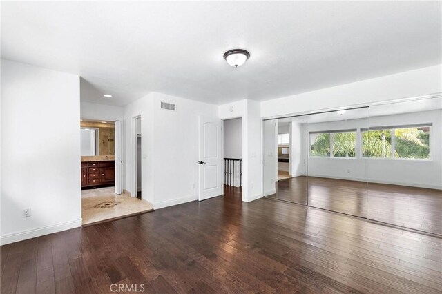 empty room with dark hardwood / wood-style floors