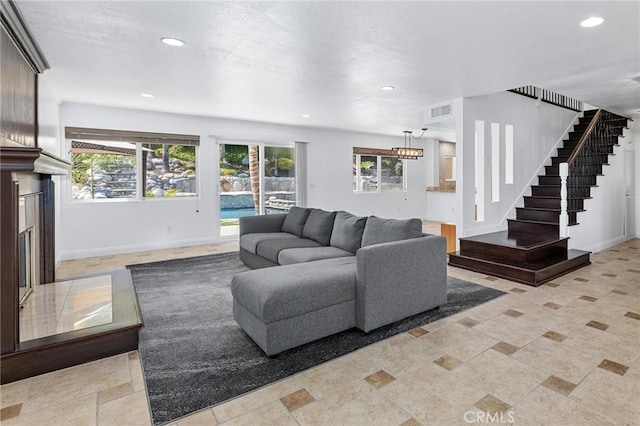 living room featuring a premium fireplace and a wealth of natural light