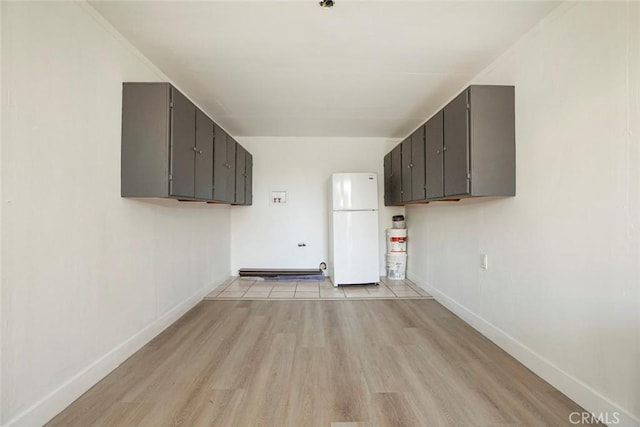 kitchen featuring white refrigerator and light hardwood / wood-style floors