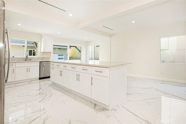 kitchen featuring sink, a kitchen island, dishwasher, and white cabinetry