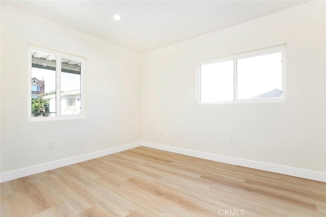 unfurnished room with light hardwood / wood-style flooring