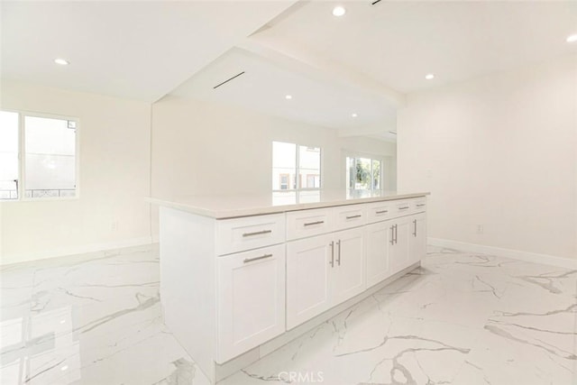 kitchen featuring white cabinets and a center island