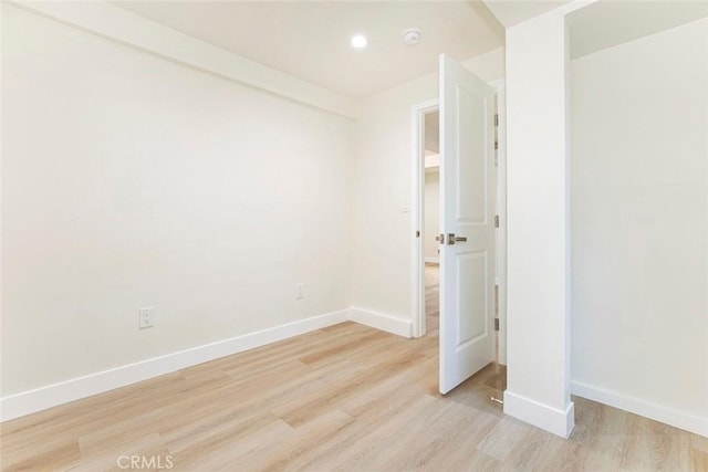 spare room with light wood-type flooring