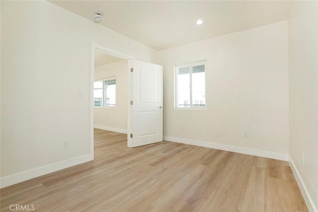 empty room with light hardwood / wood-style floors