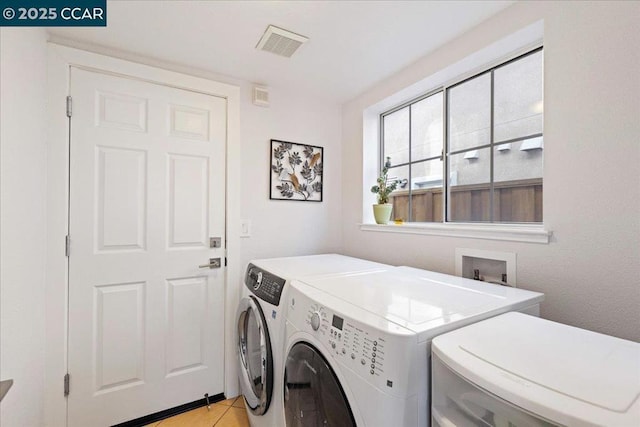 washroom featuring light tile patterned floors and washing machine and clothes dryer