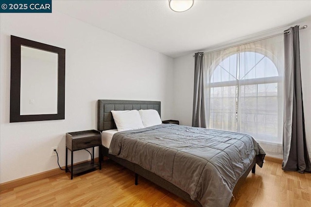 bedroom with wood-type flooring