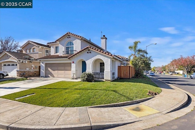 mediterranean / spanish home with a garage and a front lawn