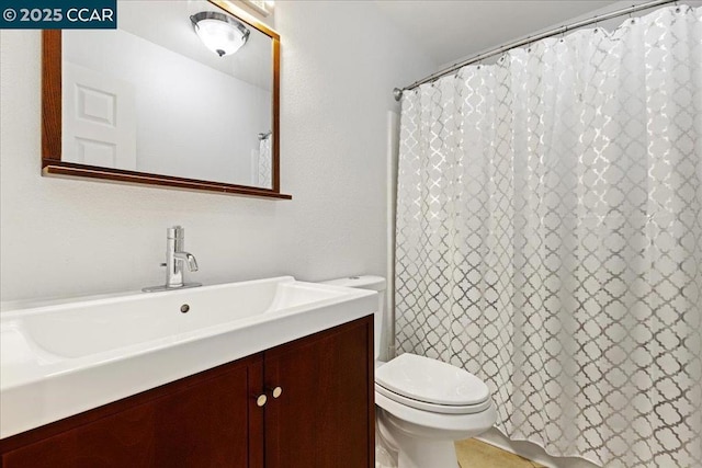 bathroom with toilet and vanity