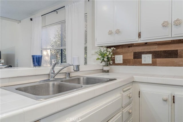 4900 E Chapman Ave Unit 24, Orange, CA 92869 - kitchen featuring a sink, white cabinets, and tile counters