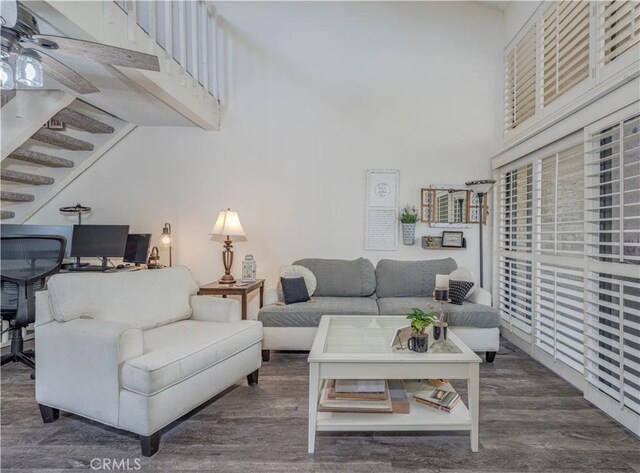 4900 E Chapman Ave Unit 24, Orange, CA 92869 - living room with wood finished floors, a towering ceiling, stairs, and ceiling fan