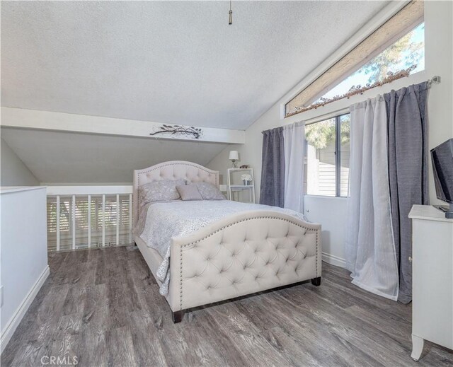 bedroom featuring lofted ceiling, a textured ceiling, and wood-type flooring