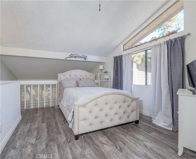 4900 E Chapman Ave Unit 24, Orange, CA 92869 - bedroom with vaulted ceiling, a textured ceiling, wood finished floors, and baseboards
