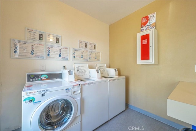 common laundry area with washer and dryer and baseboards