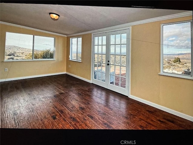 unfurnished room featuring french doors, dark wood-type flooring, and ornamental molding