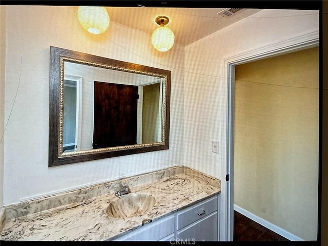 bathroom with hardwood / wood-style floors and vanity