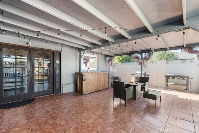 view of patio / terrace featuring a fire pit and french doors