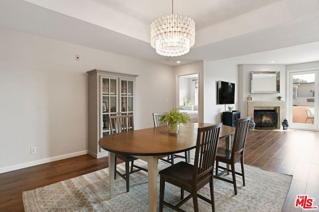 dining room featuring an inviting chandelier and dark hardwood / wood-style floors