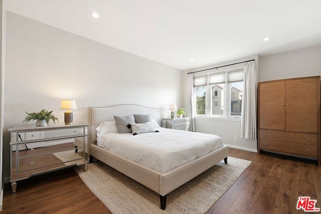 bedroom with dark wood-type flooring