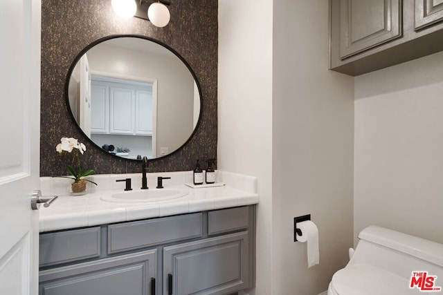 bathroom with toilet and vanity