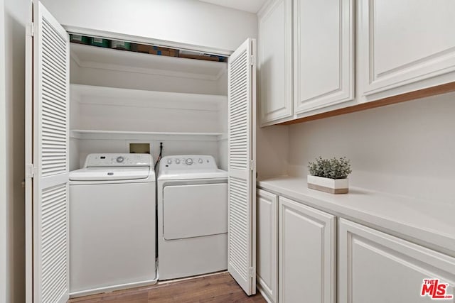 laundry room featuring dark wood-type flooring, cabinets, and independent washer and dryer