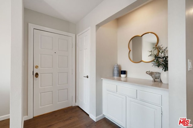 hallway with dark hardwood / wood-style flooring